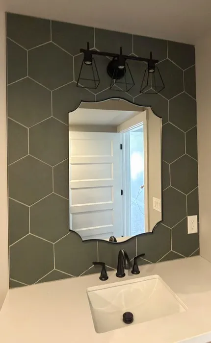 Powder bath with a hexagon tile feature wall behind the vanity